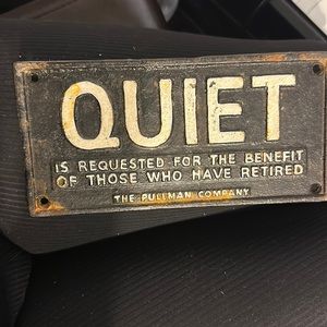 Iron sign that says quiet is requested for the benefit of those who have retired